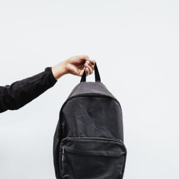 person-holding-black-backpack-3731256